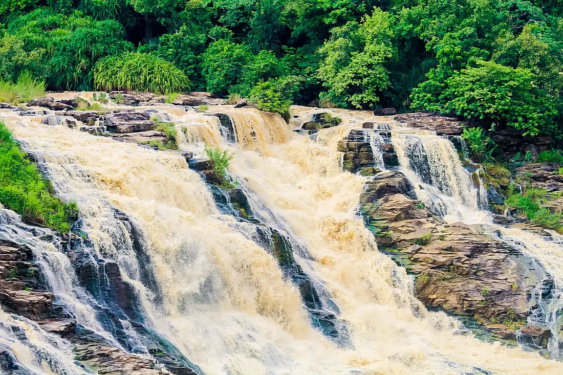 A beautiful view of the Gurara Waterfalls with lush green vegetation 01
